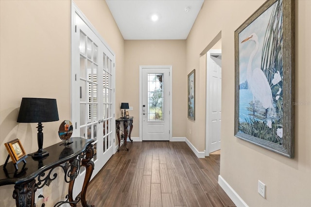 entryway with french doors, baseboards, and dark wood-style flooring