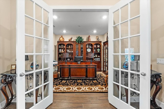 office with dark wood-style floors, recessed lighting, and french doors