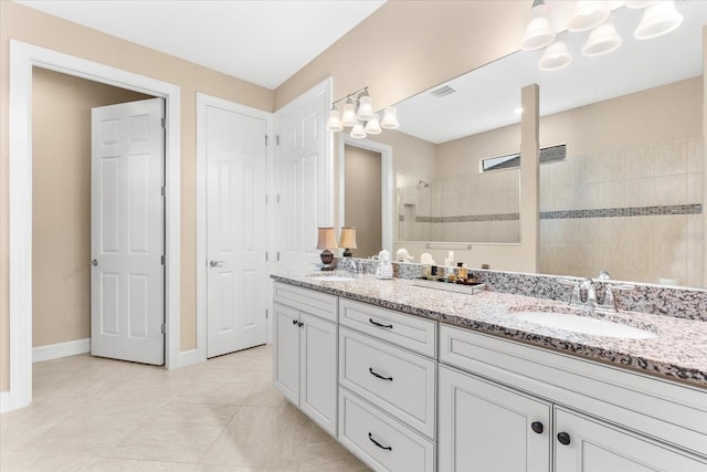 full bath with double vanity, visible vents, walk in shower, and a sink