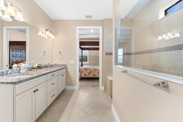 ensuite bathroom featuring visible vents, ensuite bathroom, walk in shower, and a sink