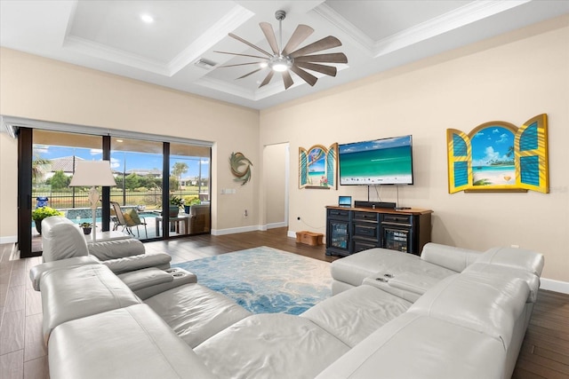 living area with visible vents, coffered ceiling, wood finished floors, baseboards, and ceiling fan