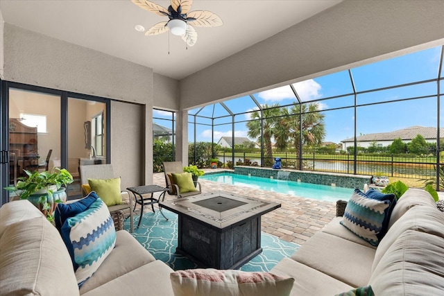 view of swimming pool with glass enclosure, an outdoor living space with a fire pit, a patio, and ceiling fan