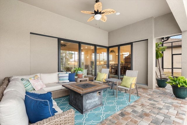 view of patio featuring an outdoor living space with a fire pit and ceiling fan