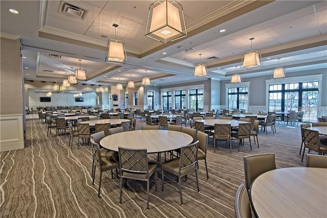 dining area featuring a decorative wall, a healthy amount of sunlight, visible vents, and wainscoting