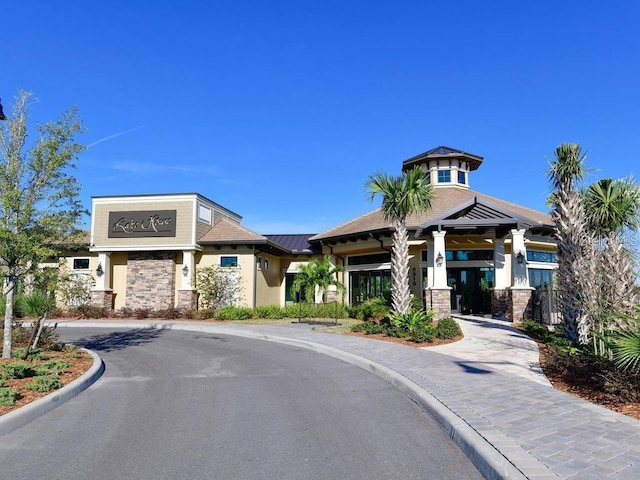 view of property featuring curved driveway