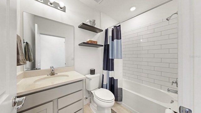 full bathroom featuring vanity, shower / tub combo, and toilet