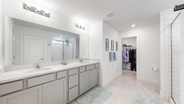 bathroom with vanity, tile patterned flooring, and walk in shower