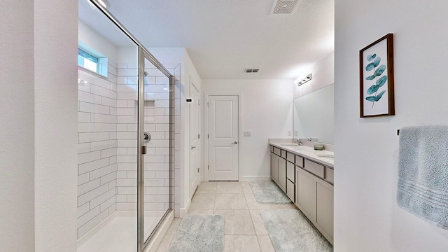 bathroom featuring vanity, an enclosed shower, and tile patterned flooring