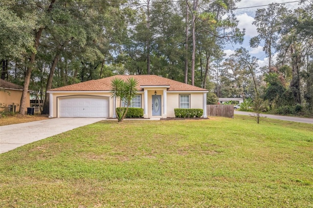 view of front of property with a front yard and a garage