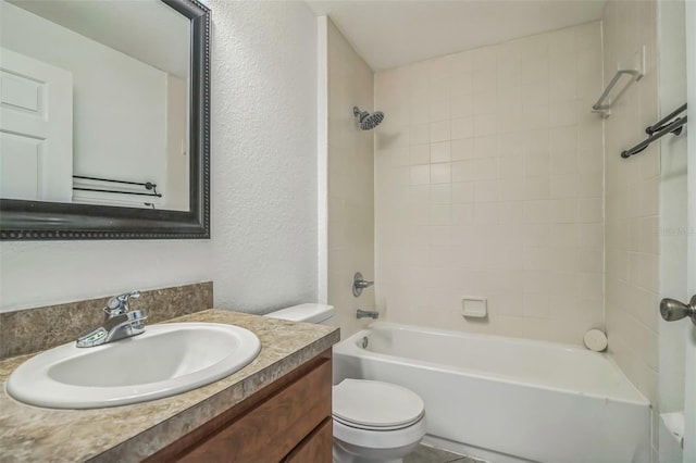 full bathroom featuring vanity, toilet, and tiled shower / bath