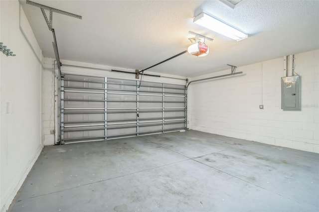 garage with a garage door opener and electric panel