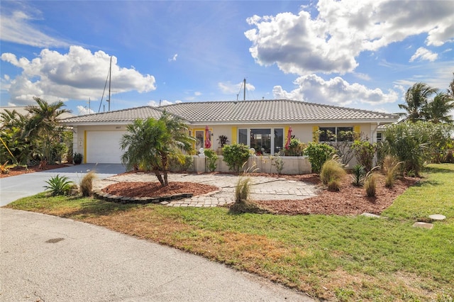 ranch-style house with a garage and a front yard