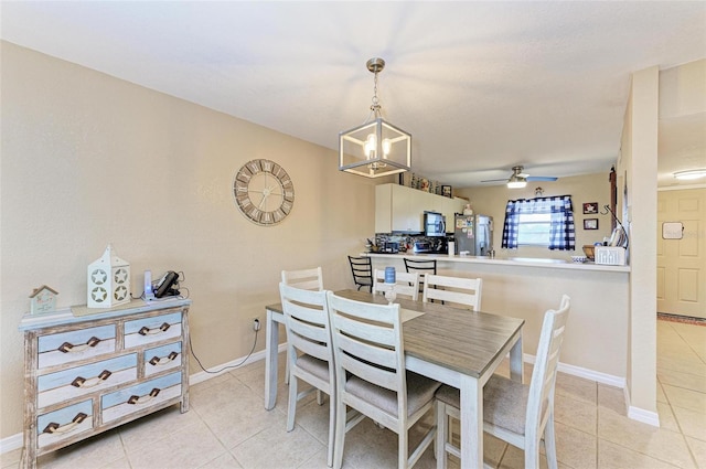 dining area with ceiling fan with notable chandelier and light tile patterned floors