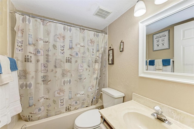 full bathroom with vanity, shower / bath combo, a textured ceiling, and toilet