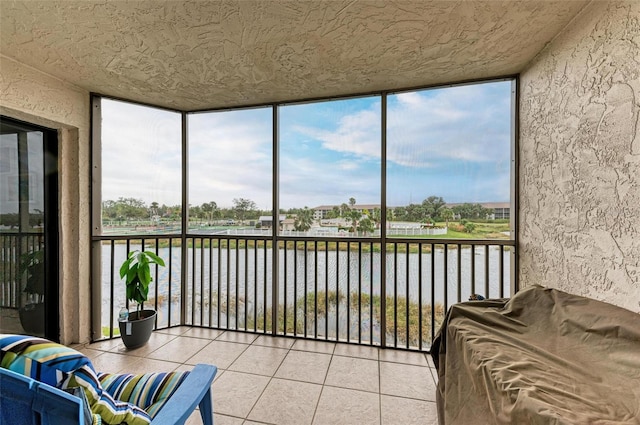 sunroom with a water view and a healthy amount of sunlight