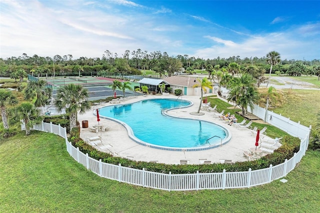 view of pool featuring a patio, a lawn, and tennis court