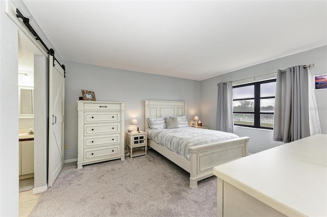 carpeted bedroom with a barn door