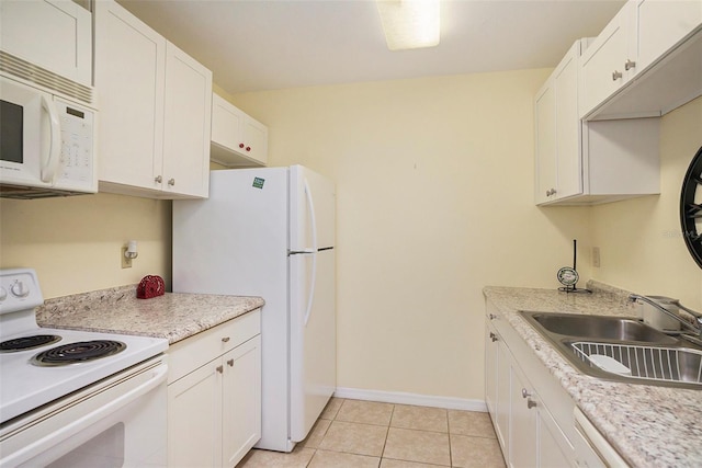 kitchen with white cabinets, white appliances, light tile patterned floors, and sink