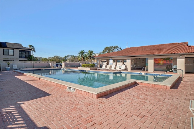 view of pool featuring a hot tub and a patio