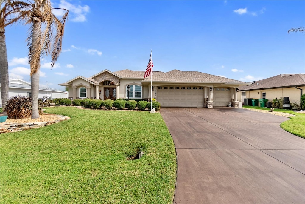 ranch-style house with a garage and a front yard