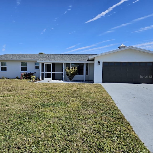 ranch-style home with a garage, a sunroom, and a front lawn