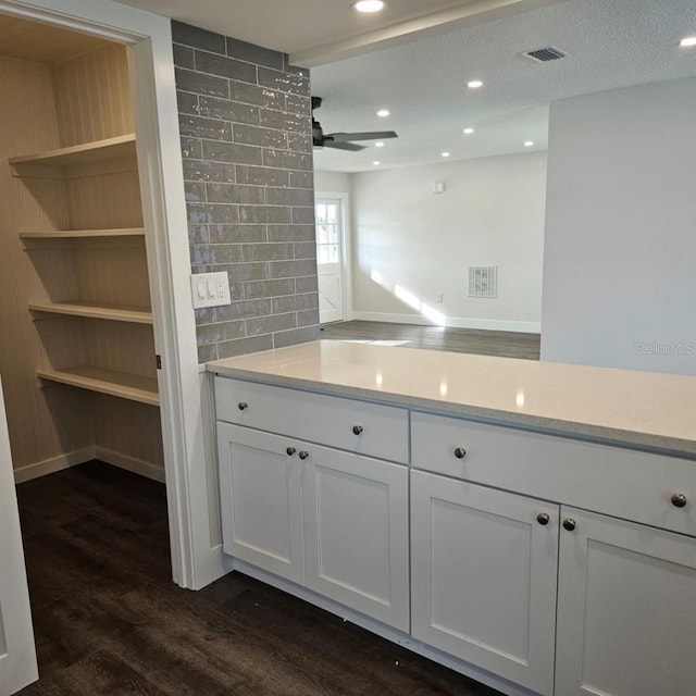 bathroom with a textured ceiling, vanity, ceiling fan, hardwood / wood-style floors, and decorative backsplash