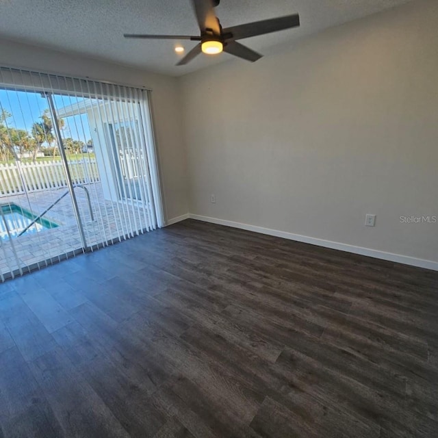 spare room featuring dark wood-type flooring, ceiling fan, and a textured ceiling