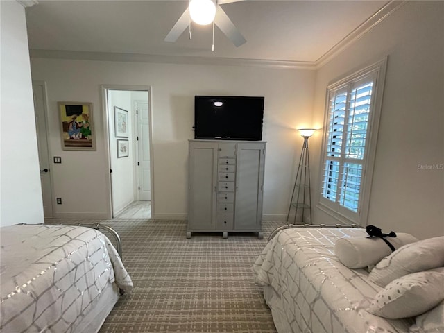 carpeted bedroom with ceiling fan and ornamental molding