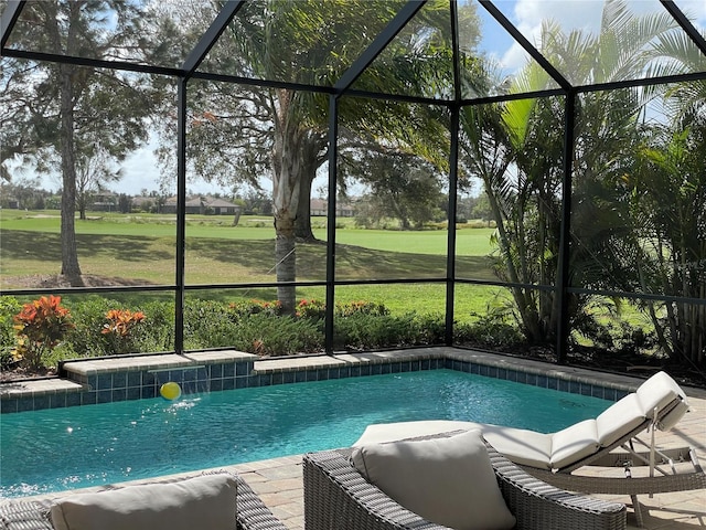 view of swimming pool with pool water feature and a lanai