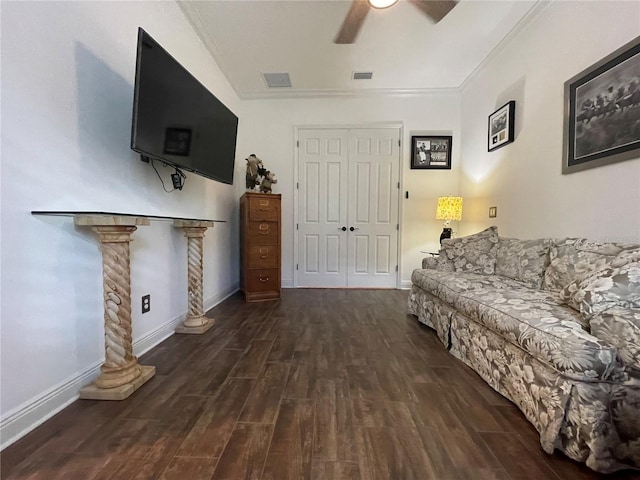 living room with ornate columns, ceiling fan, crown molding, and dark hardwood / wood-style floors