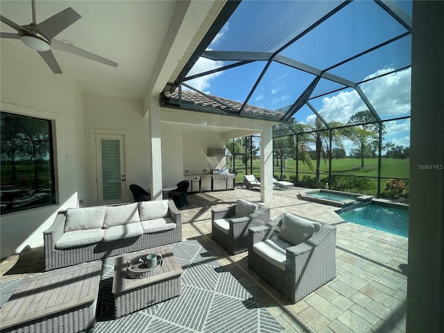 view of patio with an outdoor living space, glass enclosure, an outdoor kitchen, ceiling fan, and a swimming pool with hot tub