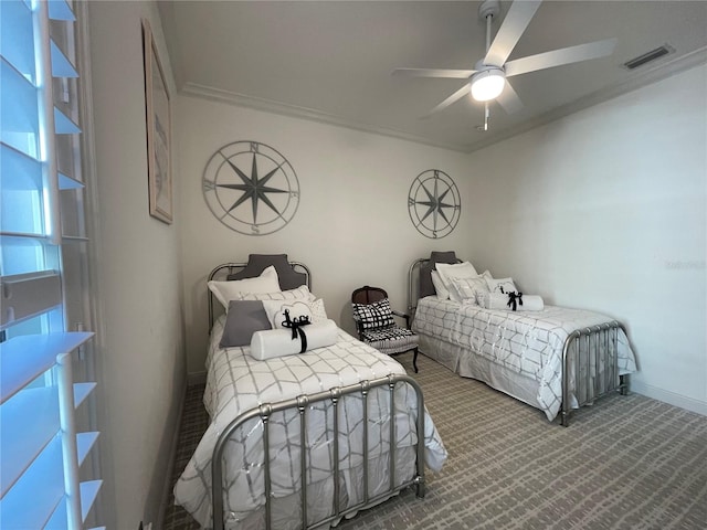 carpeted bedroom featuring ceiling fan and ornamental molding