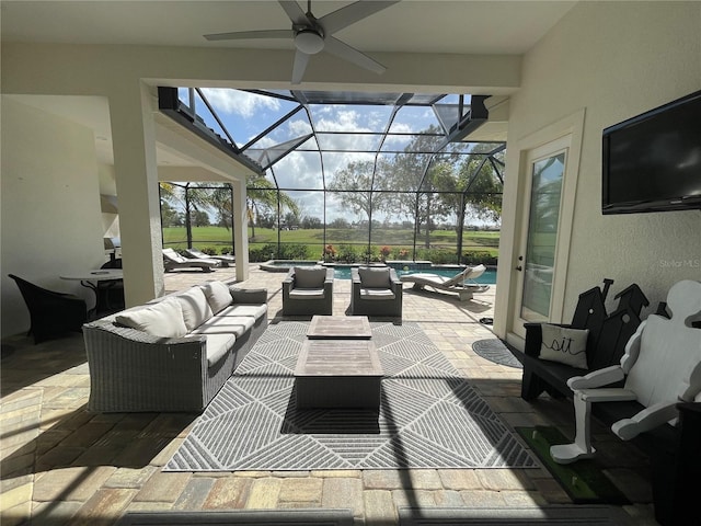 view of patio / terrace with a lanai, ceiling fan, an outdoor pool, and outdoor lounge area