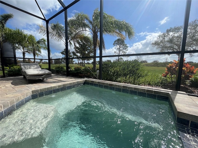 view of swimming pool with a lanai and a patio