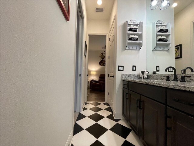 bathroom with baseboards, visible vents, ensuite bathroom, tile patterned floors, and vanity