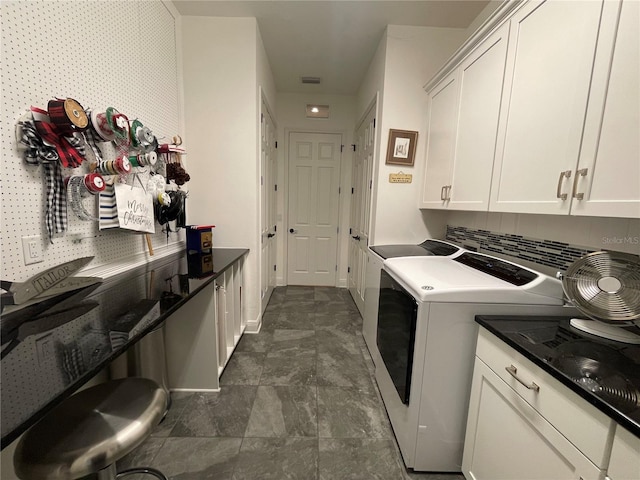 clothes washing area featuring cabinet space, baseboards, visible vents, and washer and dryer