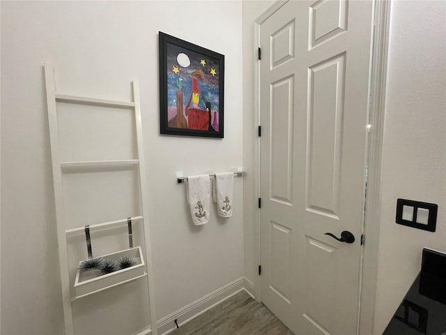 bathroom featuring wood finished floors and baseboards