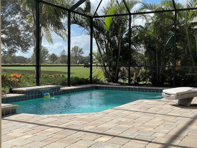 outdoor pool featuring glass enclosure and a patio