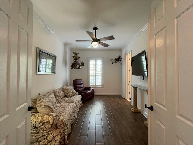 living area featuring dark wood finished floors, baseboards, a ceiling fan, and ornamental molding