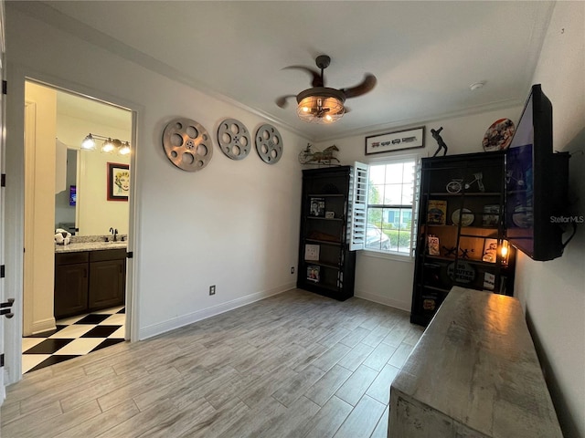 dining area with crown molding, light wood-style flooring, baseboards, and ceiling fan