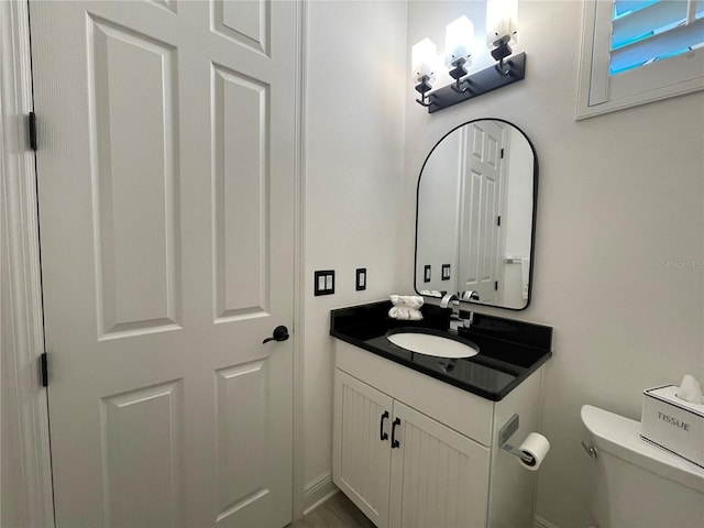 half bath with vanity and toilet