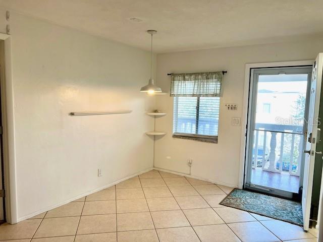 3751 S School Ave Unit 29, Sarasota, FL 34239 - unfurnished dining area with light tile patterned flooring