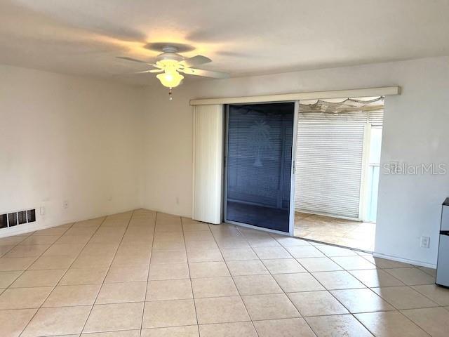 3751 S School Ave Unit 29, Sarasota, FL 34239 - empty room featuring a ceiling fan and light tile patterned floors