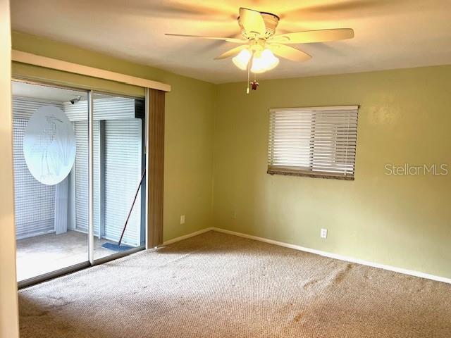 3751 S School Ave Unit 29, Sarasota, FL 34239 - unfurnished room featuring carpet floors, ceiling fan, healthy amount of natural light, and baseboards