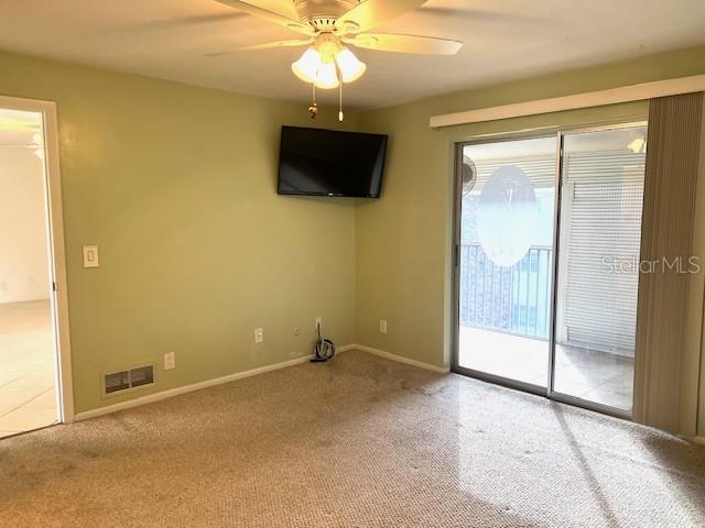 3751 S School Ave Unit 29, Sarasota, FL 34239 - carpeted spare room featuring a ceiling fan and baseboards