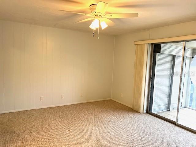 3751 S School Ave Unit 29, Sarasota, FL 34239 - unfurnished room featuring light colored carpet, ceiling fan, and baseboards