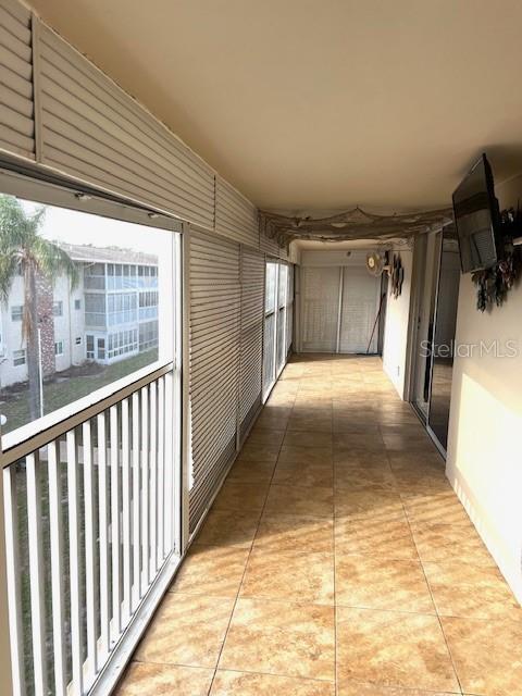 3751 S School Ave Unit 29, Sarasota, FL 34239 - hall with light tile patterned flooring