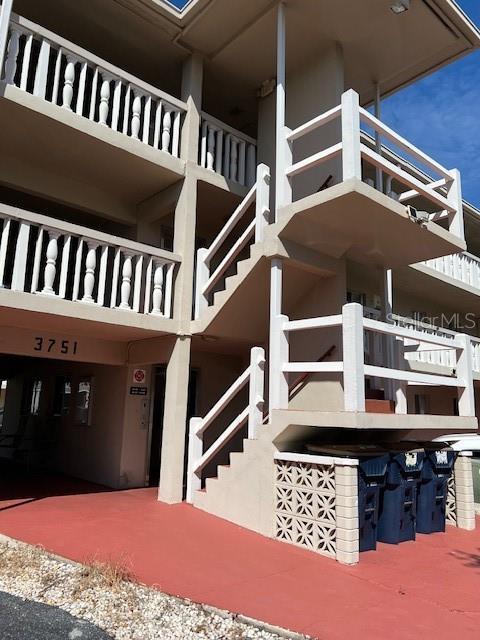 3751 S School Ave Unit 29, Sarasota, FL 34239 - view of side of property with stairway and stucco siding