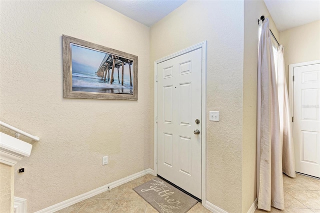 foyer entrance with light tile patterned floors