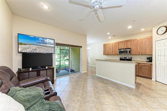 kitchen featuring a textured ceiling, stainless steel appliances, ceiling fan, and light tile patterned floors